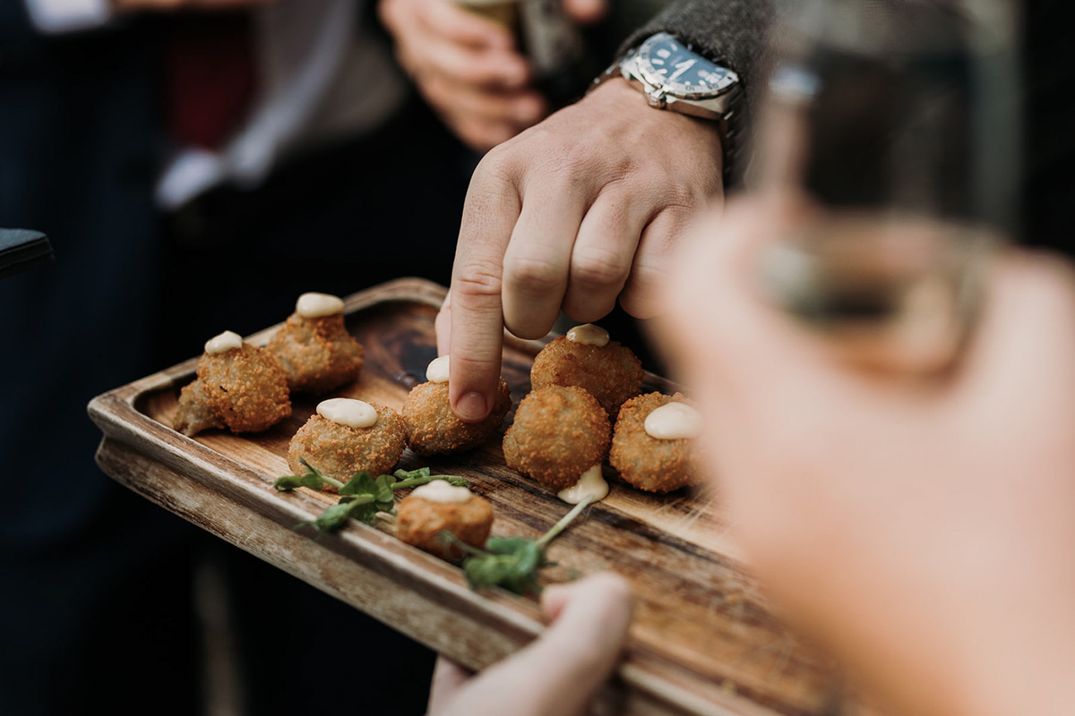 a wedding guest picking a nibble
