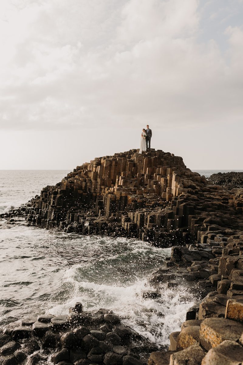 bride and groom on the stones at Giants Causeway