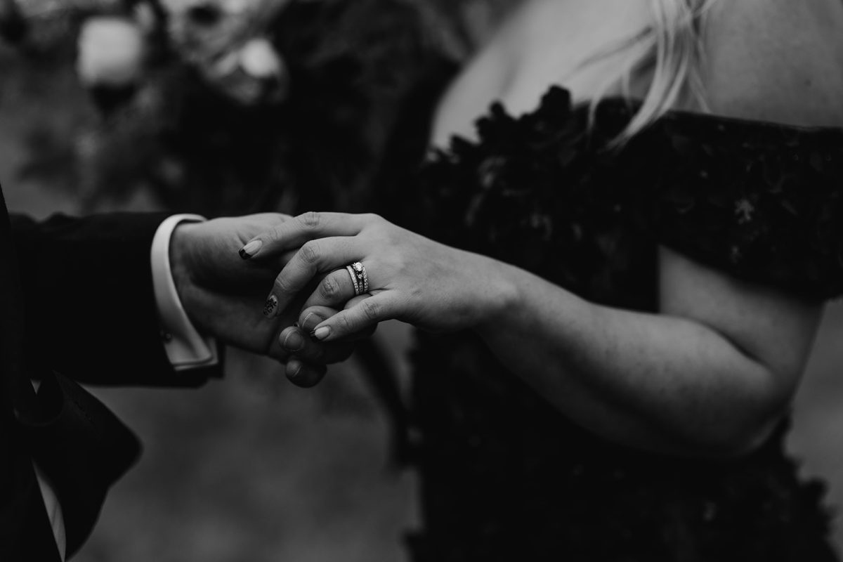 close up of bride and grooms hands