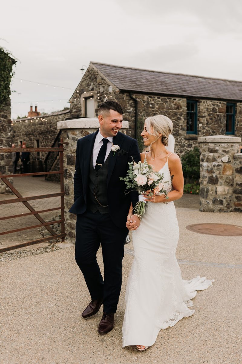 Bride and groom walking hand in hand at Limepark