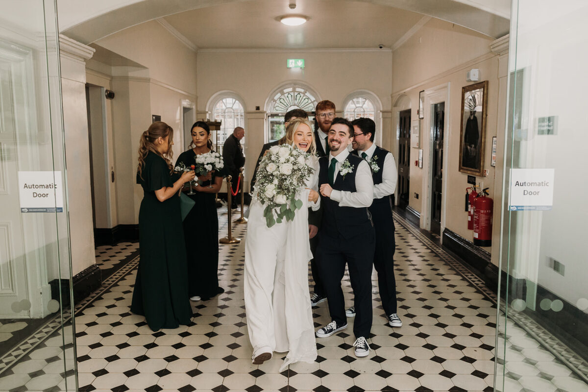 bride and groom with bridal party celebrating after ceremony at Crumlin road Gaol Belfast